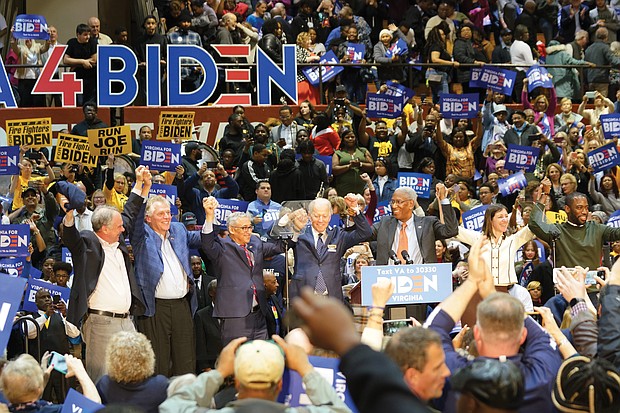 Democratic presidential hopeful Joe Biden, center, raises his arms in victory at a Norfolk rally just three days before he scored a big victory in Virginia’s presidential primary on Super Tuesday. Joining him at the rally on Saturday before a cheering crowd in the Booker T. Washington High School gymnasium are, from left, U.S. Sen. Tim Kaine, former Gov. Terry McAuliffe, U.S. Reps. Robert C. “Bobby” Scott, A. Donald McEachin and Elaine Luria and Richmond Mayor Levar M. Stoney.