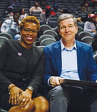 CIAA Commissioner Jacqueline McWilliams and North Carolina Gov. Roy Cooper are on the sidelines at the Spectrum Center during the tournament. The CIAA was celebrating its 75th anniversary this year.