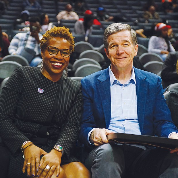 CIAA Commissioner Jacqueline McWilliams and North Carolina Gov. Roy Cooper are on the sidelines at the Spectrum Center during the tournament. The CIAA was celebrating its 75th anniversary this year.