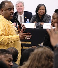 Moderator Roland S. Martin, left, takes a question from local radio host Clovia Lawrence during last Saturday’s Justice Summit at the Richmond Justice Center. Looking on are several of the summit’s nine panelists, Brian Moran, state secretary of public safety and homeland security; Valerie Boykin, director of the state Department of Juvenile Justice; and Harold W. Clarke, director of the state Department of Corrections.
