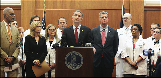 Gov. Ralph S. Northam, center, explains the state’s preparations for the coronavirus during a news conference Wednesday at the Patrick Henry Building in Downtown with several state officials. There have been no confirmed cases of the virus in Virginia so far.
