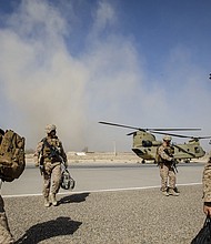U.S. Marines disembark from a U.S. Army helicopter at Camp Bost in Afghanistan’s Helmand Province, on Oct. 29, 2017