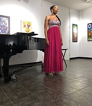 Richmond native Rachel R. Filmore sings an aria at her senior recital March 3 at Norfolk State University. The 24-year-old Armstrong High School graduate and soprano, who aspires to a career in opera,
sings in French, German, Italian, Latin and English. She also is a member of the chorus of the Virginia Opera. Ms. Filmore is the daughter of Robinette and Alfonzia Filmore, owner-operator of the Richmond- based HGFB Bus Charters Inc.