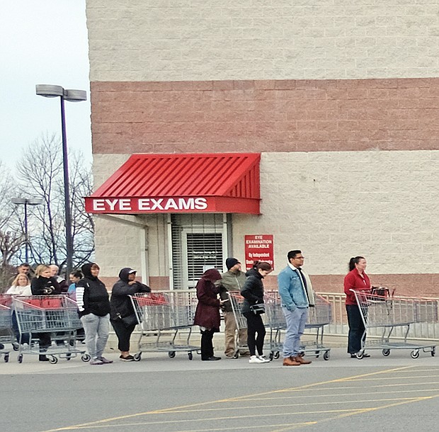 Shoppers practicing social distancing while waiting for Costco on Broad Street in Western Henrico to open last Saturday.