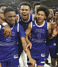 The John Marshall High School basketball team celebrates after defeating Gate City High School 75-57 to clinch the state 2A crown on March 12 at the Siegel Center in Richmond.