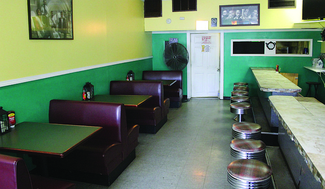 Many neighborhood restaurants like Tropic Island Jerk Chicken, 522 E. 79th St., are empty following dine-in service being suspended until March 31 by Gov. JB Pritzker. Photo credit: Wendell Hutson