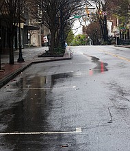 The 500 block of East Grace Street in Downtown is deserted, with similar desolate landscapes across the area as people stay home.
