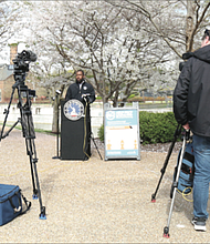 Reporters listen as Mayor Levar M. Stoney warns people on Tuesday that the city will shut down parks and other outdoor spaces if people don’t stop gathering in groups to play basketball and other games or continue to congregate at the river.