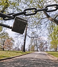 A deserted stretch of a street in Byrd Park reflects a City Hall decision to close the park gates Monday and block vehicle access to Strollers Lane, Westover Road and Trafford Road. The goal is to reduce driving inside the park and provide more space for people to move around while keeping their distance, according to the city Department of Parks, Recreation and Community Facilities.