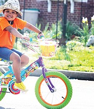 Everyone needs a break outdoors, particularly during this time of pandemic and orders to stay home and away from people. Rose Mukami Bartosh, 4, rolls along on her colorful bike, with her mom, Muthoni Imungi, not far behind last Sunday. The pair was spotted in the 3400 block of Fendall Avenue near Westwood Avenue in North Side.