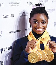 Championship gymnast Simone Biles shows off gold medals won at the 2019 World Games in Stuttgart, Germany.