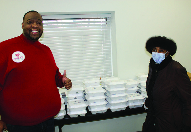 (from left) Lawrence Henderson, owner of Ruby’s restaurant, and Ald. Carrie Austin (34th) helped pass out free lunches to staff and patients at Roseland Community Hospital thanks to the generosity of Ruby’s and Good Life Soul Food Café. Photo credit: Wendell Hutson