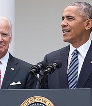 U.S. President Barack Obama, right, speaks as U.S. Vice President Joe Biden stands in the Rose Garden at the White House in Washington, D.C., U.S., on Wednesday, Nov. 9, 2016.