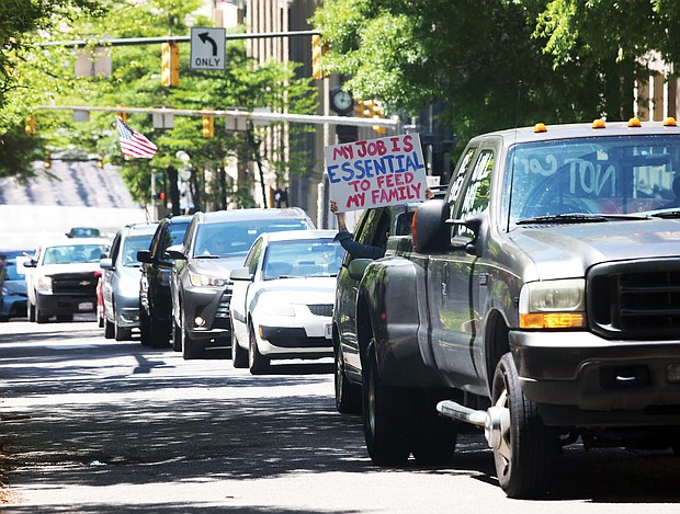 With horns honking and passengers waving signs, a line of vehicles carrying protesters descend on Downtown near the State Capitol on Wednesday demanding that Gov. Ralph S. Northam lift the restrictions put in place to curb the spread of the coronavirus and reopen Virginia’s economy.