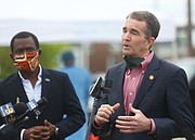 Mayor Stoney listens to Gov. Northam speaking