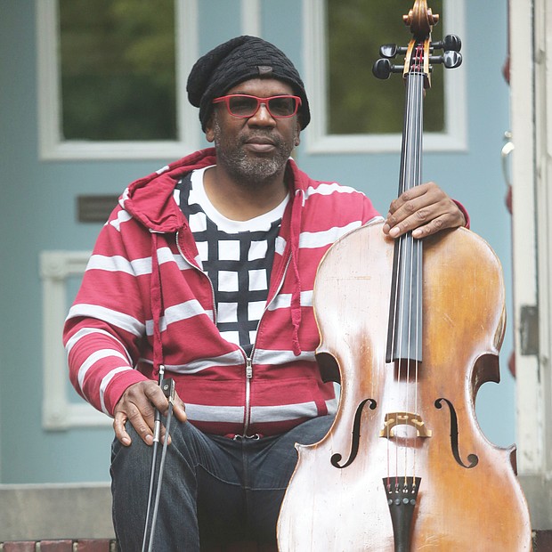 Paul Rucker, a visual artist, musician and composer, sits with his cello on the steps of his home in Downtown. He is an iCubed Arts Research Fellow at Virginia Commonwealth University. The pandemic, he said, “offers those, especially with privilege, a time for reflection. I think this is an opportunity to evaluate and move in new directions. This is not a time for fear.”