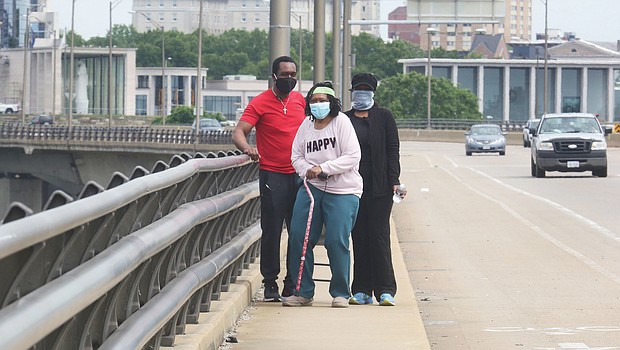 Corrine V. “Coco” McClaine starts on her birthday walk April 29 with her son, Scott B. McClaine, and her daughter, Dr. Arvid A. McClaine. Location: The Lee Bridge. The Virginia War Memorial is in the background.