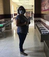 Linda Estrada, secretary at Runn Elementary in Donna, Texas, assembles student packets. (photo: Clarissa Lopez)