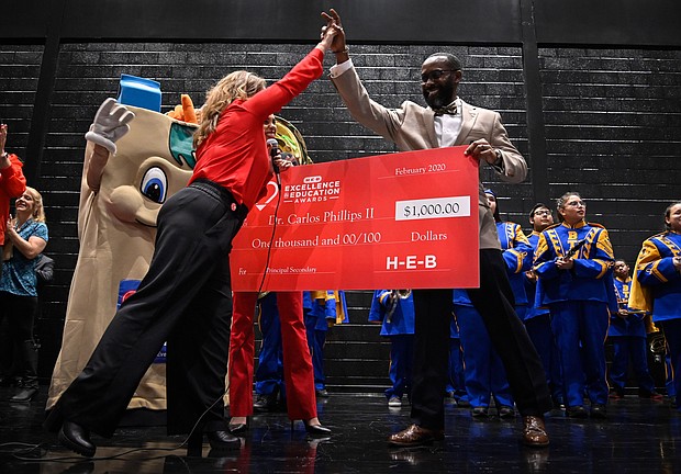Booker T. Washington High School Principal Carlos Phillips received a $10,000 cash prize and a $25,000 grant for Washington High School