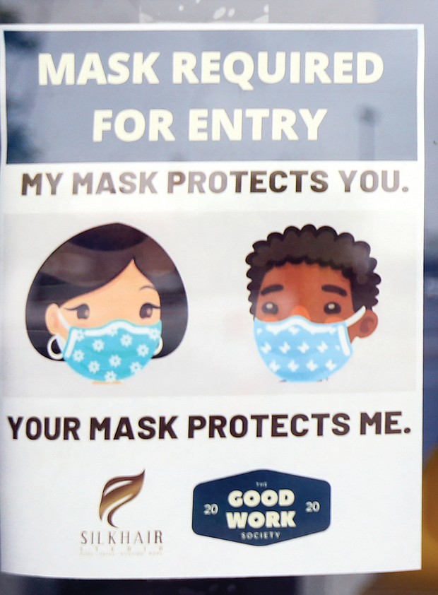This sign on the front door of Silk Hair Studio reminds people that masks are required for entry into the building.
