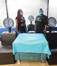 Hair stylists Renada Harris, 39, left, and Kim Washington, 52, make preparations to reopen Silk Hair Studio, which they have co-owned for 12 years. The shop in the 1600 block of West Broad Street has been shuttered since March 24, but they hope the shutdown will end next week when Richmond enters Phase One of the state’s reopening.