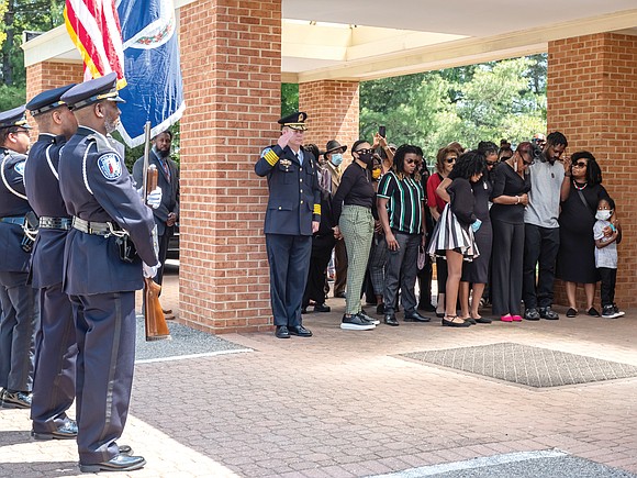 Richmond Police Chief Will Smith salutes and the department’s Honor Guard stands at attention as the family of the late ...