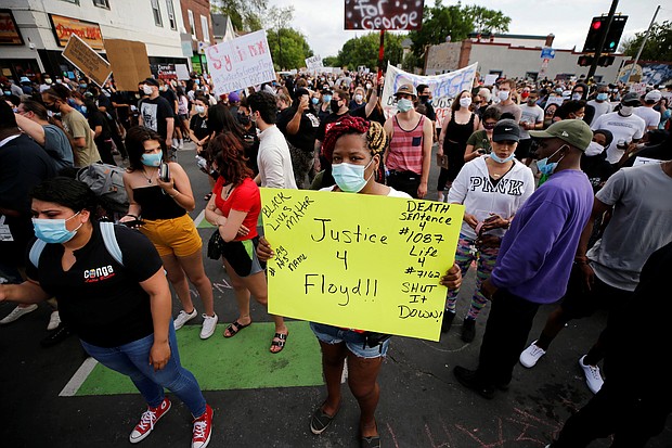 A sea of protesters gather at the site in Minneapolis where a white police officer intentionally kneeled on the neck of George Floyd. Mr. Floyd later was pronounced dead at a nearby hospital.