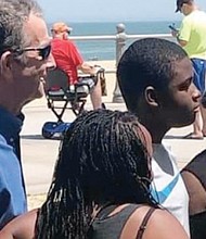 Gov. Northam poses for photos with beachgoers Saturday at Virginia Beach. He, like many others, was not wearing a face mask or socially distancing as he and health officials have called for to help curb COVID-19.