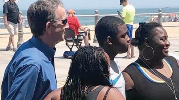 Gov. Northam poses for photos with beachgoers Saturday at Virginia Beach. He, like many others, was not wearing a face mask or socially distancing as he and health officials have called for to help curb COVID-19.