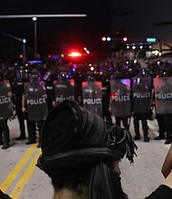 Police watch as demonstrators block a roadway while protesting the death of George Floyd in Miami. Photo: Joe Raedle/Getty Images