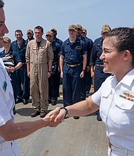 Lt. Shelby Ramirez, right, is congratulated by Cmdr. Ameian Jeremiah, 
executive officer of USS James E. Williams, for her promotion in rank.