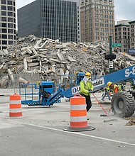 Nine nearly simultaneous explosions were triggered to bring the 42-year-old building down, leaving the debris for workers and heavy equipment to remove. The implosion was rated a success; there were no reports of damage to nearby buildings or city utilities. Scores of people found vantage points outside the 15-block safety zone to see the event live, while others watched on TV or via Dominion’s lives- tream. Dominion is contemplating plans to construct a new building on the site. Already, the company has erected the first of two towers next door at 600 E. Canal St. and has approval to build a matching tower on the site where One James River Plaza stood.