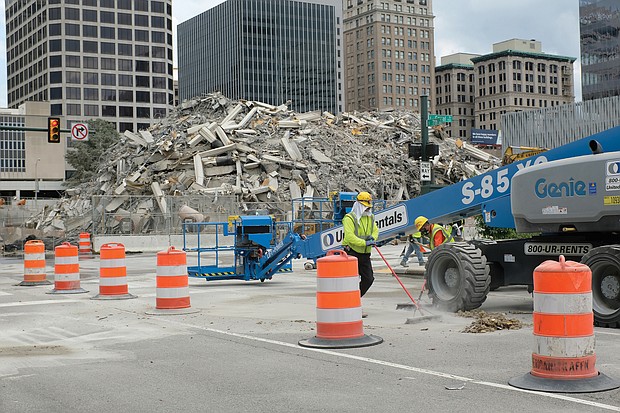 Nine nearly simultaneous explosions were triggered to bring the 42-year-old building down, leaving the debris for workers and heavy equipment to remove. The implosion was rated a success; there were no reports of damage to nearby buildings or city utilities. Scores of people found vantage points outside the 15-block safety zone to see the event live, while others watched on TV or via Dominion’s lives- tream. Dominion is contemplating plans to construct a new building on the site. Already, the company has erected the first of two towers next door at 600 E. Canal St. and has approval to build a matching tower on the site where One James River Plaza stood.