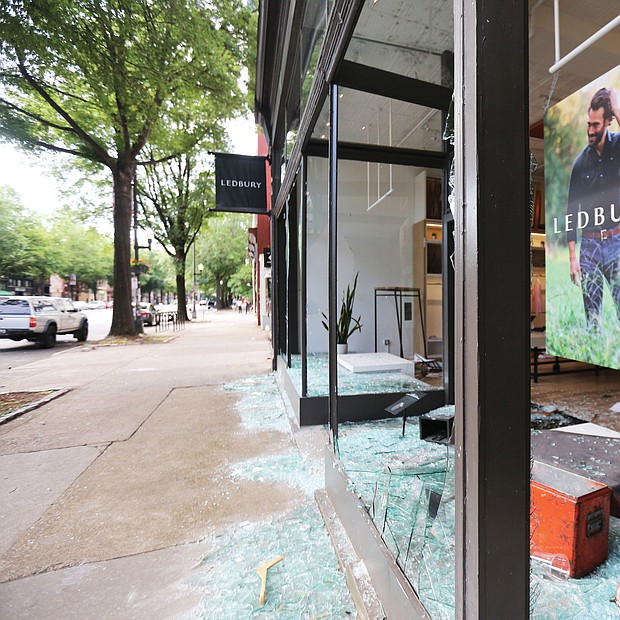 Paul Trible, owner of menswear and shirtmaker Ledbury, looks out of the glassless window of his storefront at 315 W. Broad St., one of the Downtown stores that was looted.