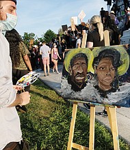 in the midst of the crowd gathered Tuesday at the Lee statue, Kyle Rudd paints a picture honoring George Floyd of Minneapolis and Breonna Taylor of Louisville, both victims of police violence. The march and rally around him on Tuesday was peaceful.