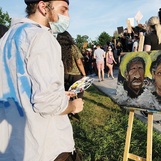 in the midst of the crowd gathered Tuesday at the Lee statue, Kyle Rudd paints a picture honoring George Floyd of Minneapolis and Breonna Taylor of Louisville, both victims of police violence. The march and rally around him on Tuesday was peaceful.