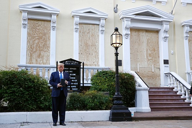 President Trump holds a Bible on Monday outside St. John’s Church across Lafayette Park from the White House. Part of the church was set on fire during rioting Sunday night.