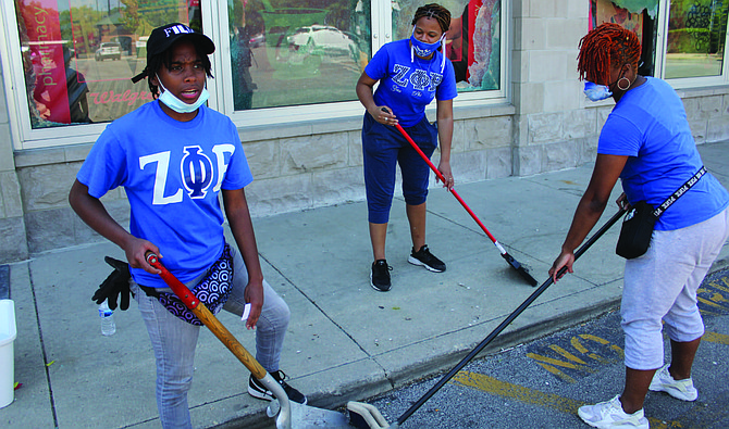 (from left) Rhonda Nunn, Jovun Shaw and Savannah Wallace volunteered to help clean up at Walgreens, 1533 E. 67th St., following last week’s looting spree across Chicago. Photo credit: Wendell Hutson