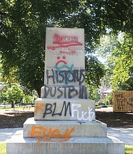 Above, the graffiti-tagged pedestal is all that remains where the statue of Confederate Gen. Williams Carter Wickham once stood in Monroe Park. Protesters pulled down the statue Saturday night. The Virginia National Guard reportedly now has it.