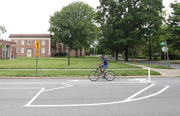 A cyclist pedals along one of the newly installed bike lanes on Brook Road near Westbrook Avenue. A sign explains that parking is allowed to the left in a former travel lane, while bikes stay to the right. More than $1 million in federal funds was spent to install the 3.5-mile stretch in Richmond of bike lanes along Brook Road between Azalea Avenue and Charity Street. Providing room for bikes and street parking is restricting vehicle traffic to one lane in each direction on Brook Road, although there are turn lanes for vehicles at major intersections. Work began after City Hall shut down in mid-March due to the pandemic and is essentially complete. The total $1.5 million installation project also included funding for bike lanes on Malvern Avenue and a portion of Patterson Avenue, according to the city Department of Public Works.