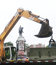 Heavy equipment is on the scene as concrete barriers are placed around the Lee statue on Wednesday. The state Department of General Services installed the barriers as a safety precaution while it maps out the removal of the statue under an order from Gov. Ralph S. Northam.