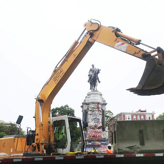 Heavy equipment is on the scene as concrete barriers are placed around the Lee statue on Wednesday. The state Department of General Services installed the barriers as a safety precaution while it maps out the removal of the statue under an order from Gov. Ralph S. Northam.