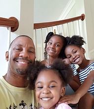 Mahcoe Mikel with his daughters