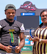 Kevin Gayles of Huguenot High School and Jayla Henderson of Thomas Jefferson High School display their awards as the Richmond Public Schools 2020 Scholar-Athletes during a June 4 event at The Diamond.
