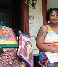 Unicia R. Buster displays some of her art quilts as she works from the front porch of her East End home on her poster design for the 32nd Annual 2nd Street Festival.