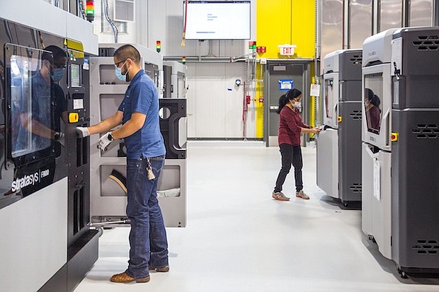 General Motors additive manufacturing team members working at the still-under-construction Additive Innovation Center. (Photo by Jeffrey Sauger for General Motors)