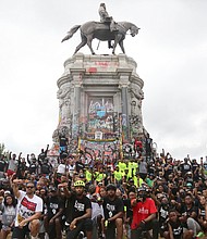 Cyclists participating in the Black Lives Matter Father’s Day Bike Ride pause to take a group picture Sunday in front of the Lee statue during the ride through the city.The Urban Cycling Group and R&B singer Trey Songz organized the unifying event that drew hundreds to ride peacefully through the city.