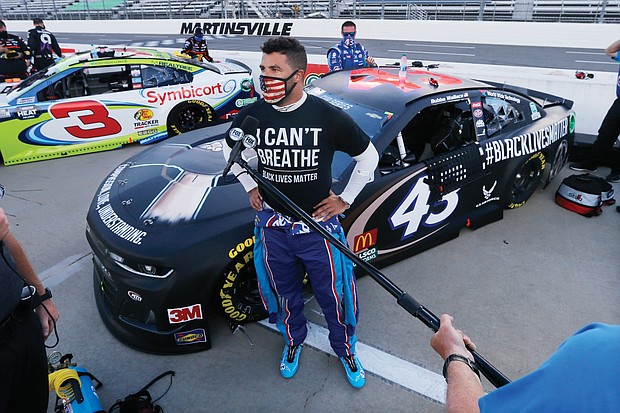 Driver Bubba Wallace waits for the start of a NASCAR Cup Series auto race June 10 in Martinsville.