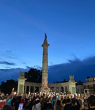 Hundreds gather for a Juneteenth candlelight vigil in front of the former monument to Confederate President Jefferson Davis, whose statue already has been torn down. The display capped the all-day celebration of the liberation of slaves on Friday, June 19. R&B singer Trey Songz was among the participants in the candlelight event that began at the Lee statue and culminated at the Davis monument.