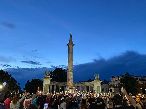 Hundreds gather for a Juneteenth candlelight vigil in front of the former monument to Confederate President Jefferson Davis, whose statue already has been torn down. The display capped the all-day celebration of the liberation of slaves on Friday, June 19. R&B singer Trey Songz was among the participants in the candlelight event that began at the Lee statue and culminated at the Davis monument.